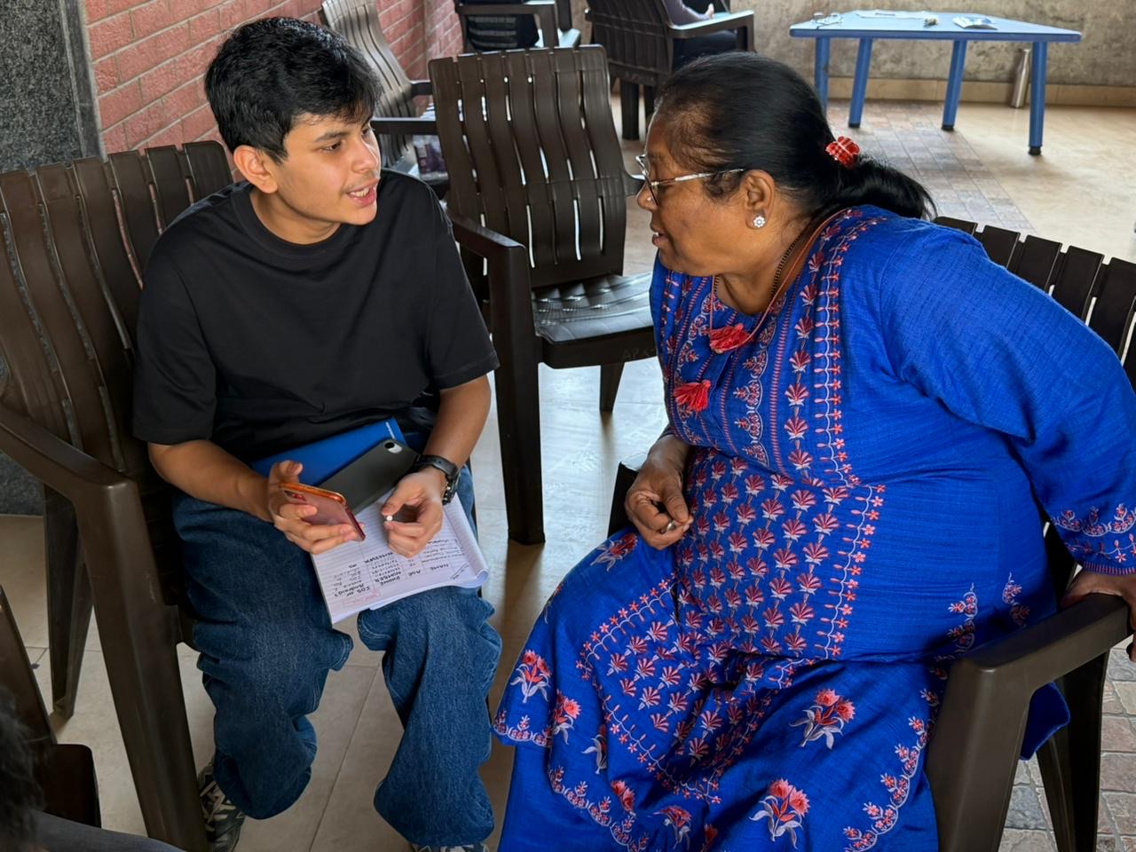 Female volunteer showing a tablet to an elderly woman