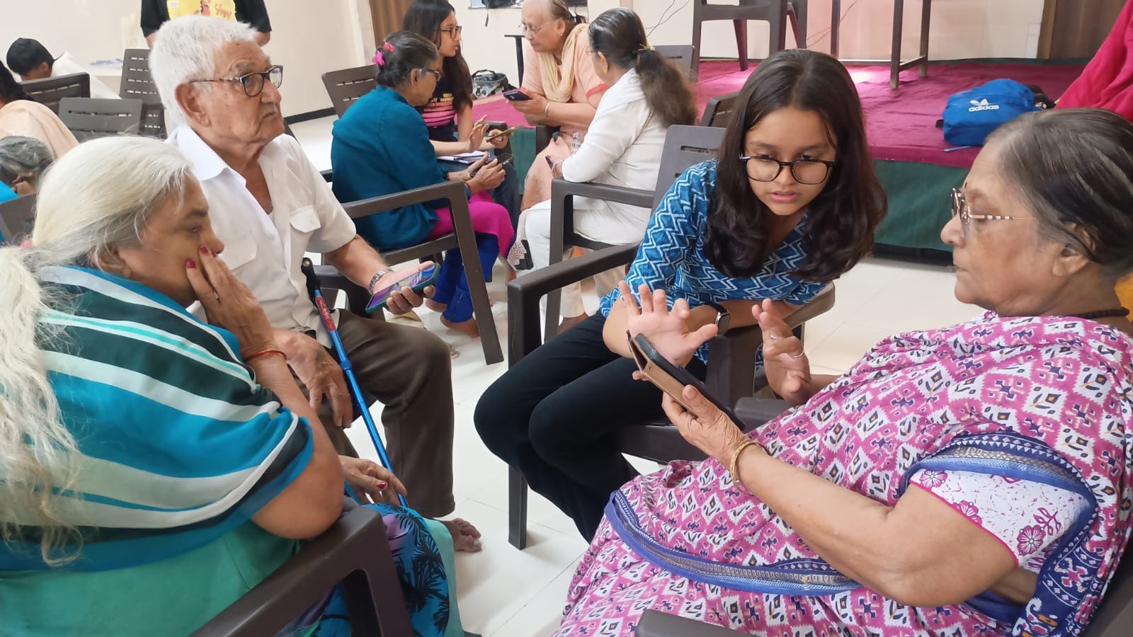 Volunteer leading a group discussion with senior citizens